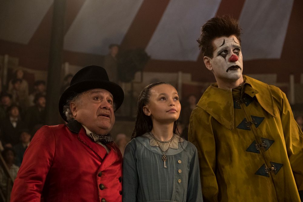 CLOWNING AROUND -- In Tim Burton’s all-new, live-action reimagining of “Dumbo,” circus owner Max Medici (Danny DeVito) calls on former circus star Holt Farrier (Colin Farrell) to care for a newborn elephant whose oversized ears make him a laughingstock in an already struggling circus. Holt ultimately takes his task very seriously—even donning a clown suit to help the flying elephant as he emerges as a star. Daughter Milly (Nico Parker) just might be Dumbo’s biggest fan. “Dumbo” flies into theaters on March 29, 2019. Photo by Jay Maidment. © 2018 Disney Enterprises, Inc. All Rights Reserved.